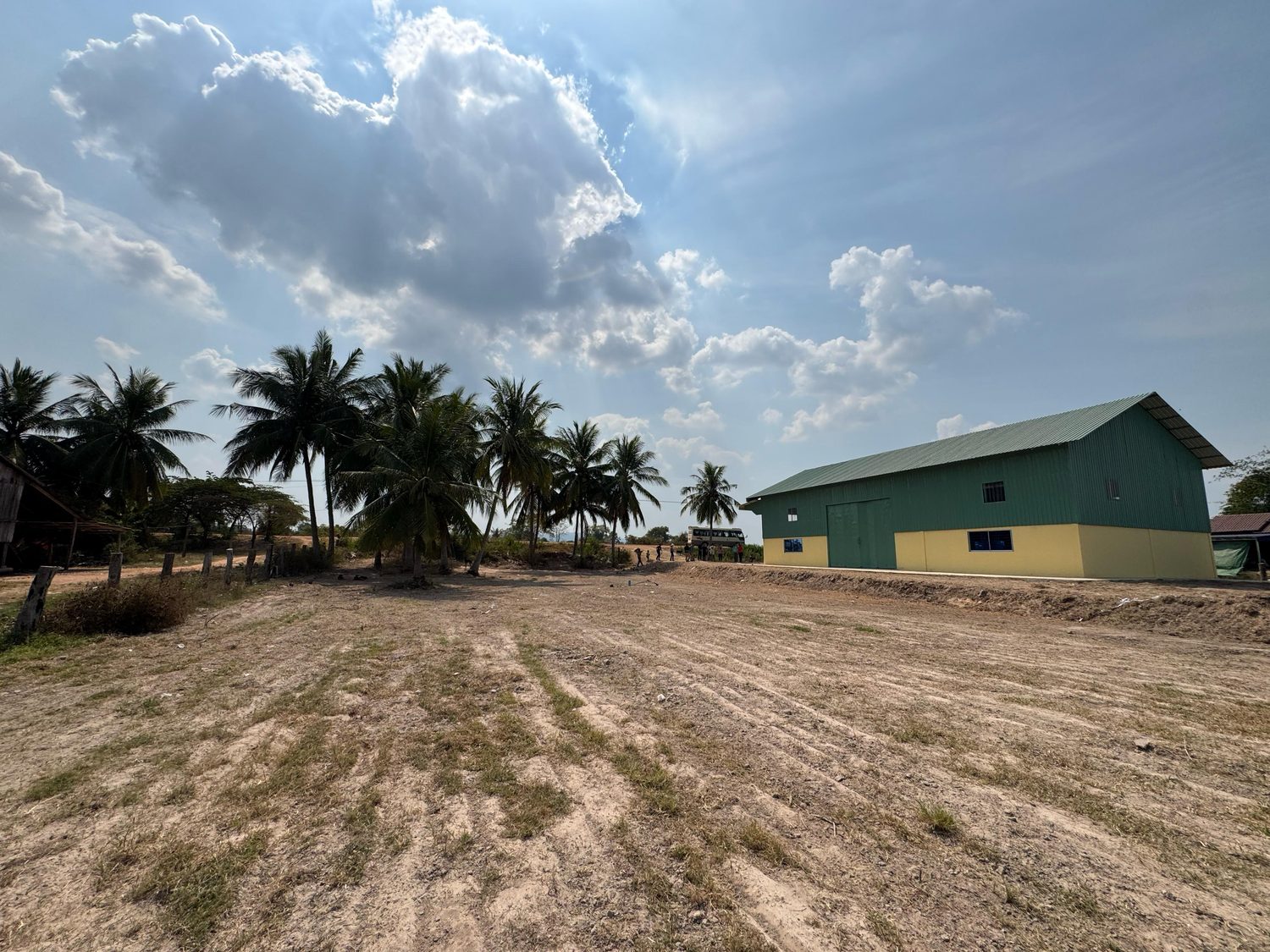 The finished raised ground stretching toward the ministry building and palm trees